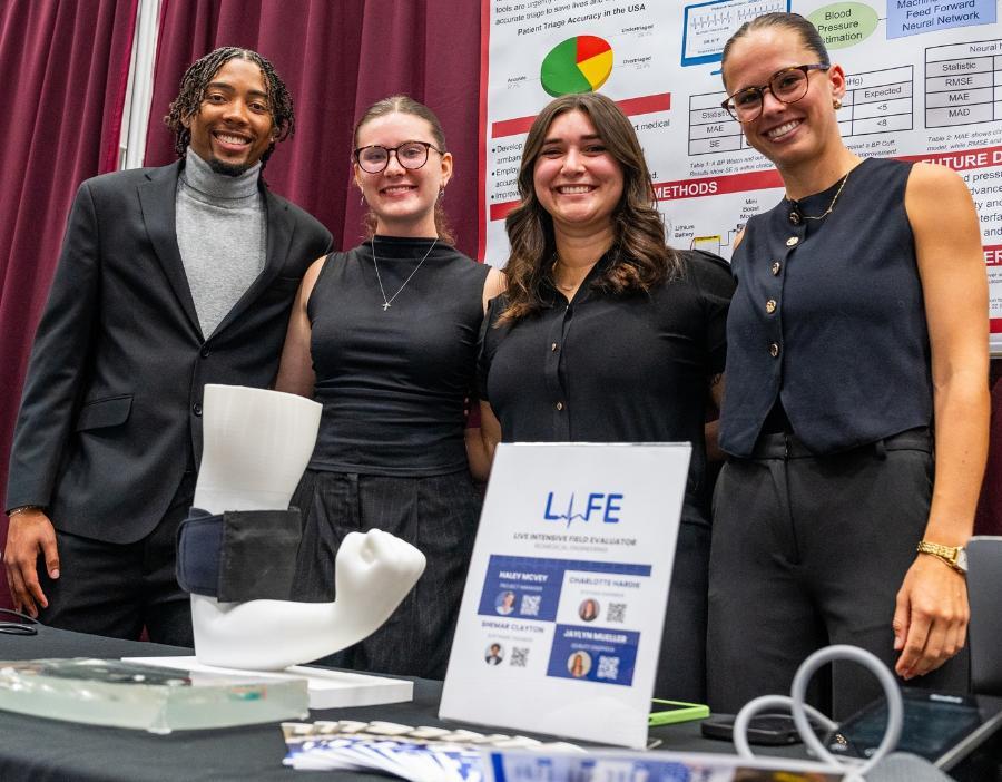 Students presenting their project, the L.I.F.E. Live Intensive Field Evaluator, at the Student Design Showcase.