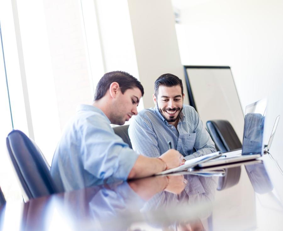 Students consult with each other in a conference room