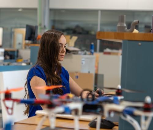 An aeronautics engineering student working on a computer in the student design center
