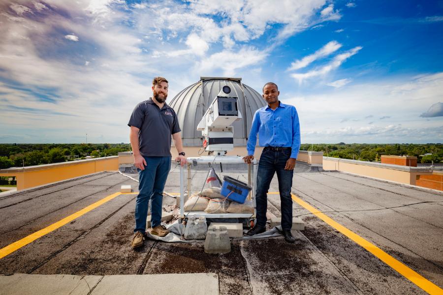 Student researchers setting up a high-speed camera on the roof of the Olin Physical Sciences building to capture images of lightning for research.