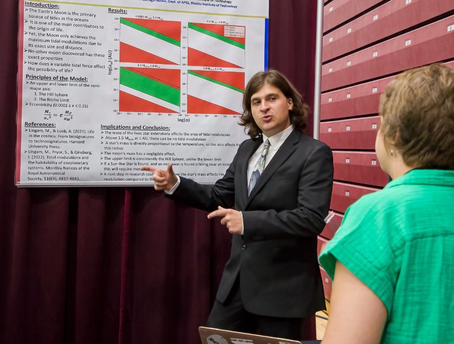 A student presenting his planetary science research at the student design showcase