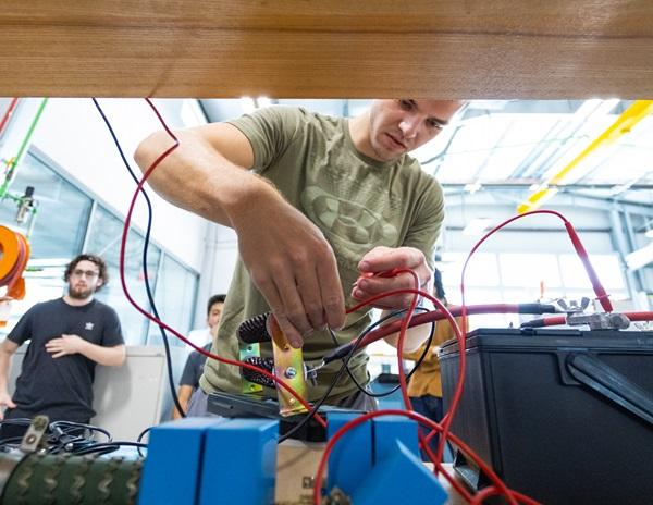 Student working on electric vehicle senior project