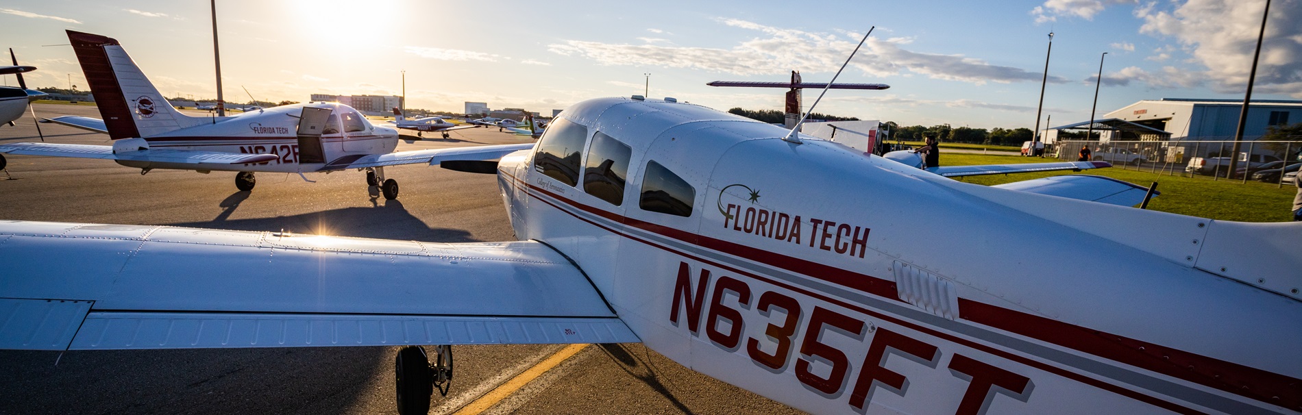 Two of our aircraft fleet with the Florida Tech aviation hangar in the background