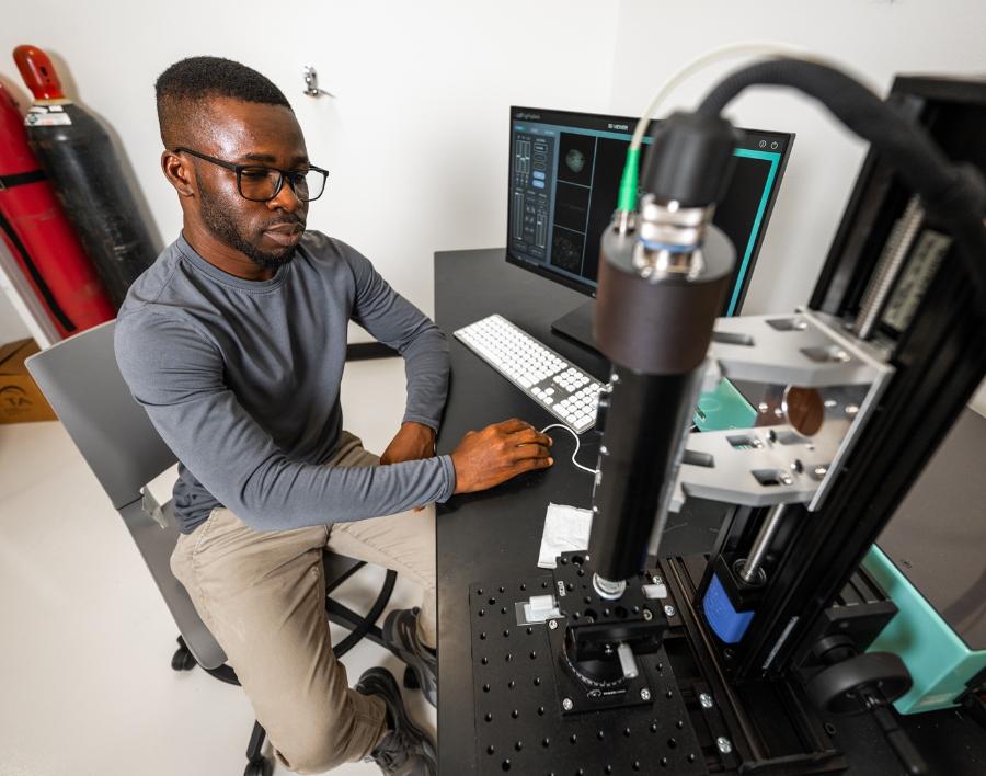 A mechanical engineering doctoral student working in a lab.