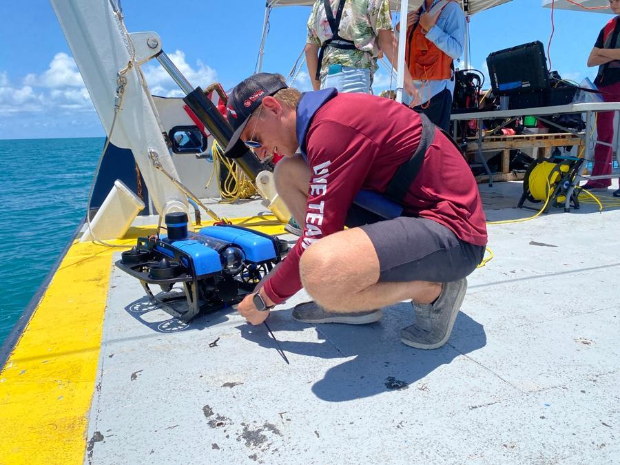 An ocean engineering student working on deck on the marine field projects cruise