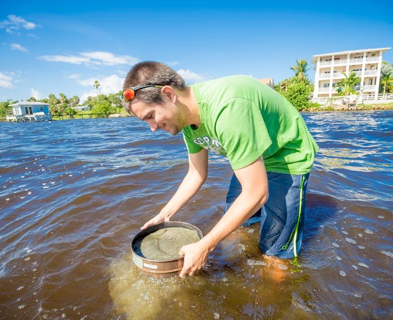 A student collecting samples in the Indian River Lagoon