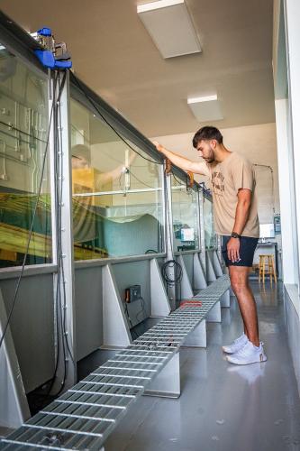 A student conducting research in the wave tank