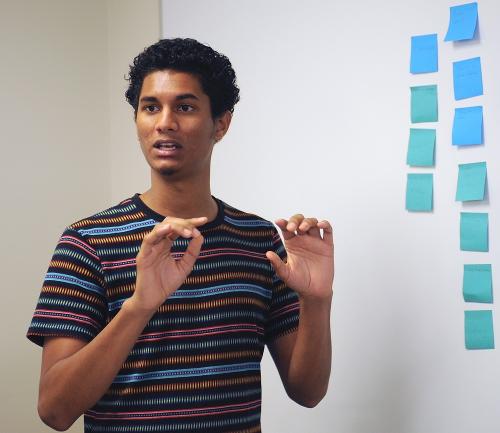 A student leads a group discussion and brainstorming session.