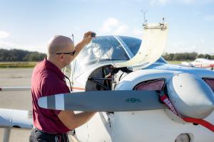 Performing preventative maintenance and safety checks on a Florida Tech plane.