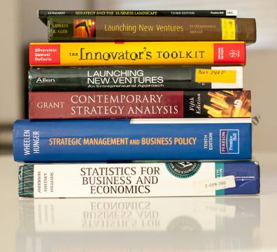 a stack of books with titles for starting up a business