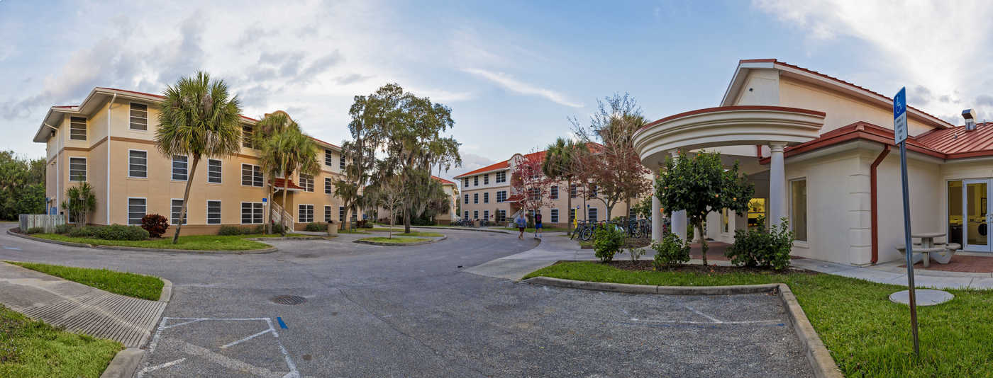 A panoramic view of columbia village showing a group of large stucco apartment buildings